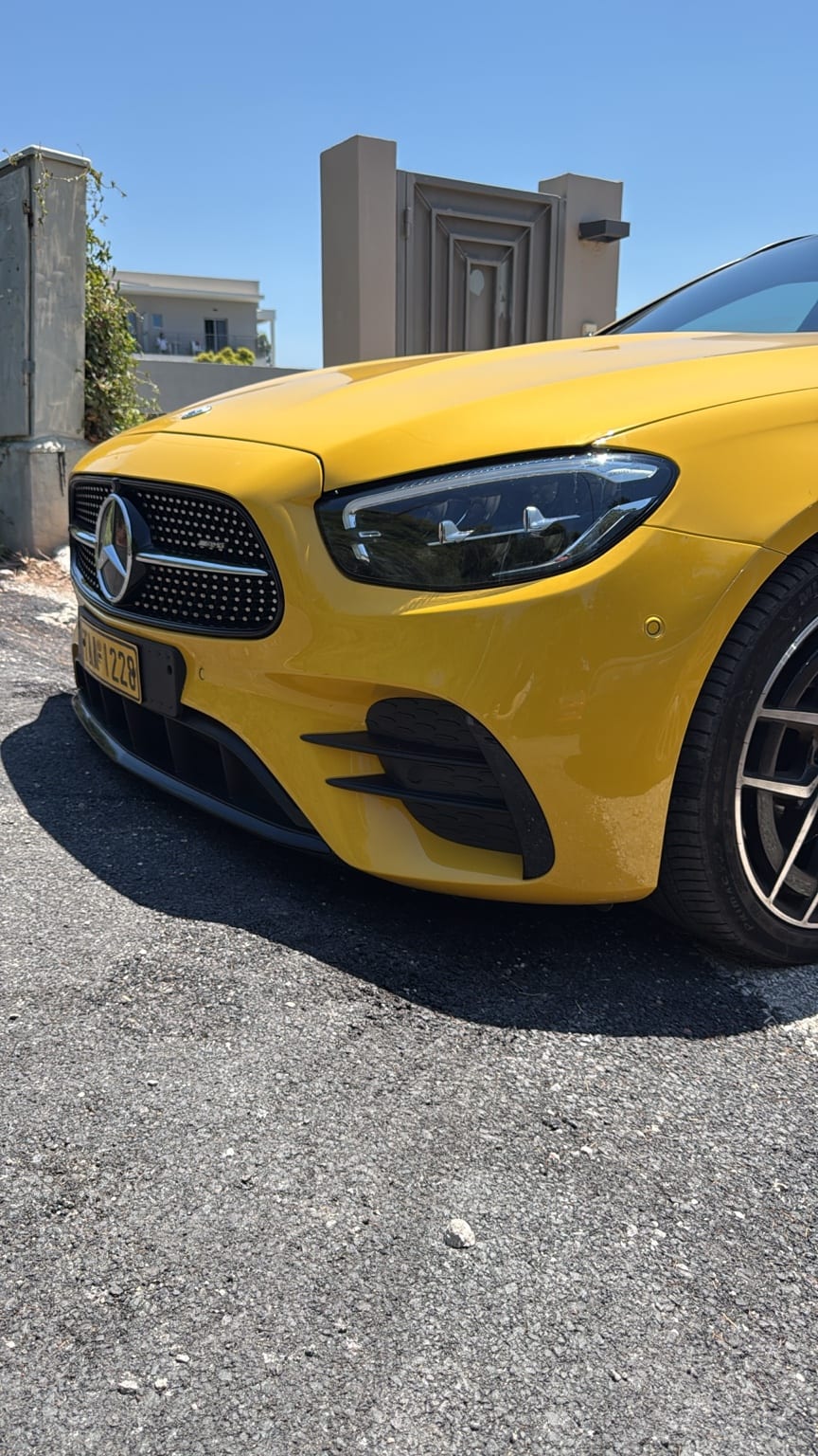 Close-up of the taxi's front end showing the Mercedes-Benz star in the diamond grille and the LED headlight
