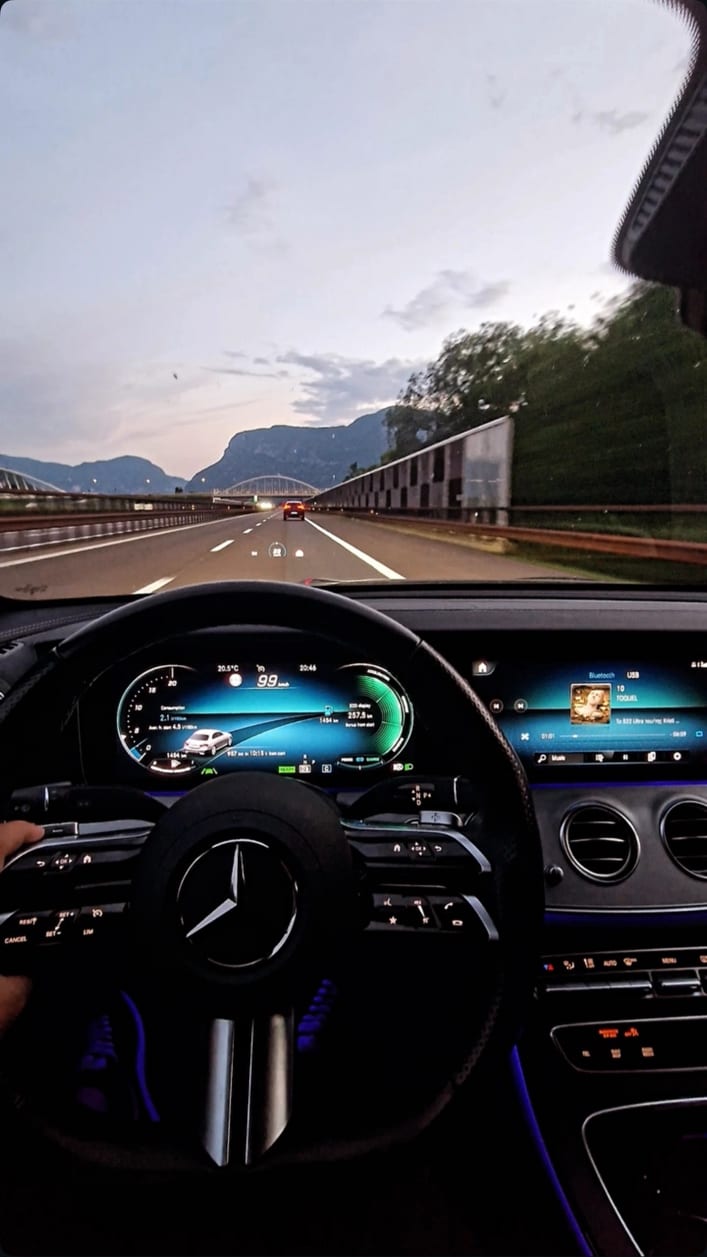 View from the driver's seat while on the motorway, showing the taxi's twin digital displays and leather steering wheel